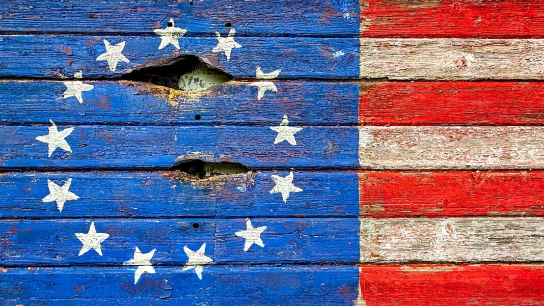 Weathered american flag painted on wooden planks.