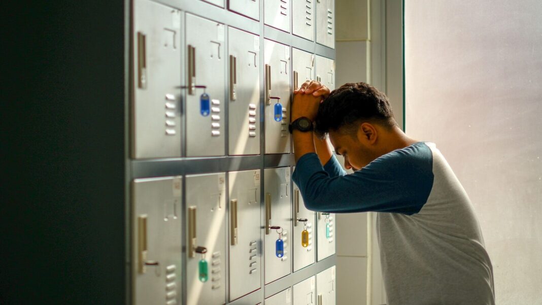 woman in blue long sleeve shirt standing near white cabinet