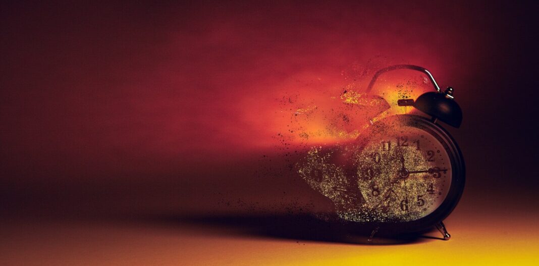 Alarm clock disintegrating into smoke and embers.